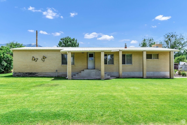 162 E 200 N, Monroe, UT 84754 - view of front facade featuring a front yard, brick siding, and a chimney