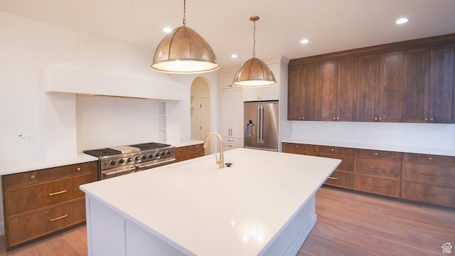 589 E 3800 N Unit 175, North Ogden, UT 84414 - kitchen with premium appliances, a sink, light countertops, light wood finished floors, and recessed lighting