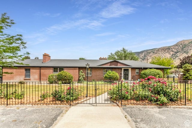 611 E 100 N, Brigham City, UT 84302 - ranch-style home with brick siding, a mountain view, and a chimney