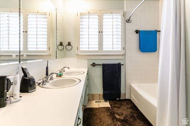 611 E 100 N, Brigham City, UT 84302 - bathroom featuring double vanity, healthy amount of natural light, and shower / bath combo with shower curtain