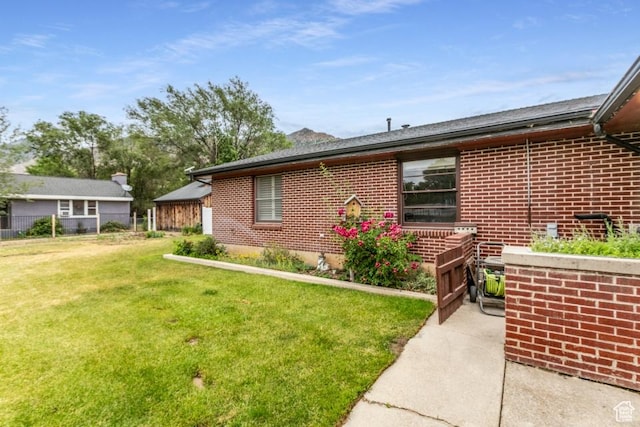 611 E 100 N, Brigham City, UT 84302 - view of side of property featuring brick siding and a lawn