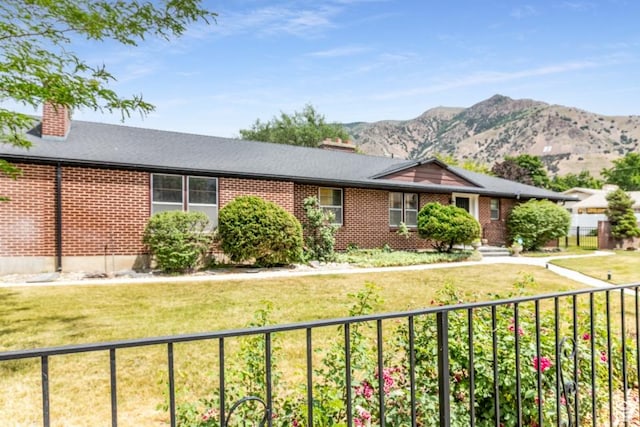 611 E 100 N, Brigham City, UT 84302 - single story home featuring a chimney, brick siding, a mountain view, and a front yard