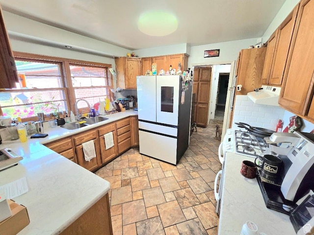 611 E 100 N, Brigham City, UT 84302 - kitchen featuring freestanding refrigerator, stone tile flooring, a sink, under cabinet range hood, and light countertops