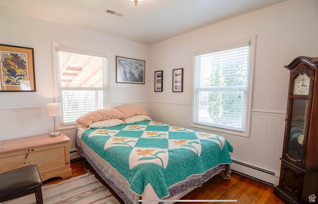 331 W Elberta Dr, Pleasant View, UT 84414 - bedroom featuring a baseboard radiator, multiple windows, wainscoting, and wood finished floors