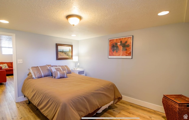 331 W Elberta Dr, Pleasant View, UT 84414 - bedroom featuring light wood-style flooring, a textured ceiling, baseboards, and recessed lighting