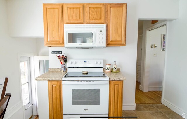 331 W Elberta Dr, Pleasant View, UT 84414 - kitchen with white appliances, light tile patterned flooring, and baseboards