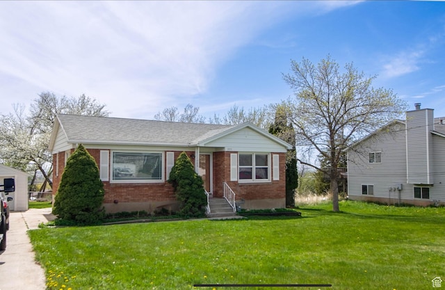 331 W Elberta Dr, Pleasant View, UT 84414 - view of front of property with brick siding, a front lawn, and roof with shingles