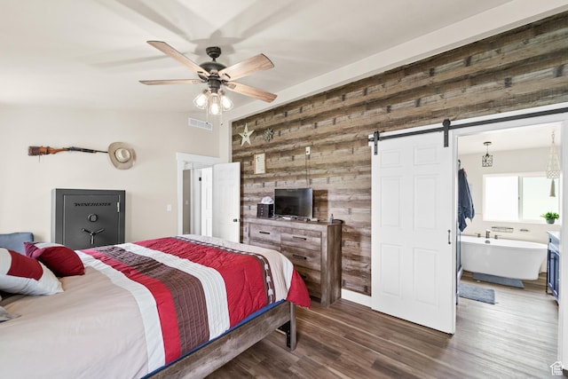 1665 E 1280 N, Mount Pleasant, UT 84647 - bedroom featuring wood walls, a barn door, vaulted ceiling, wood finished floors, and ceiling fan