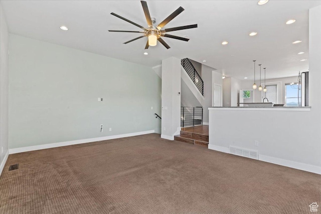 4746 W S Jordan Pkwy, South Jordan, UT 84009 - unfurnished living room featuring carpet flooring, recessed lighting, baseboards, and stairway