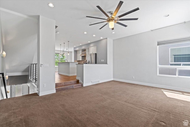 4746 W S Jordan Pkwy, South Jordan, UT 84009 - unfurnished living room featuring carpet floors, a ceiling fan, baseboards, and recessed lighting