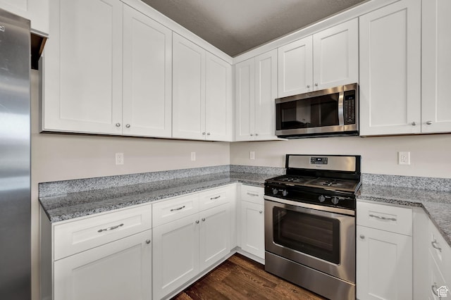 1712 W Naxos Ln, South Jordan, UT 84095 - kitchen featuring stainless steel appliances, dark wood finished floors, white cabinets, and light stone countertops