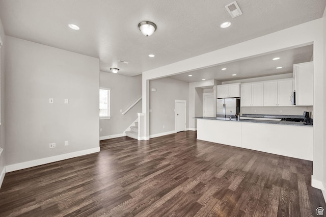 1712 W Naxos Ln, South Jordan, UT 84095 - unfurnished living room featuring stairs, dark wood-style floors, baseboards, and recessed lighting