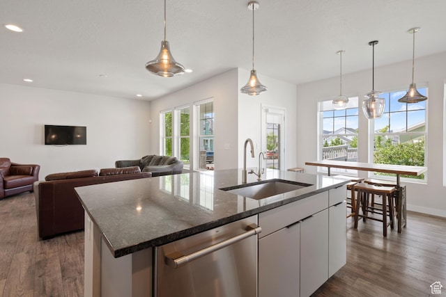 5206 W Mellow Way S, South Jordan, UT 84009 - kitchen featuring a sink, dishwasher, recessed lighting, a center island with sink, and dark stone counters