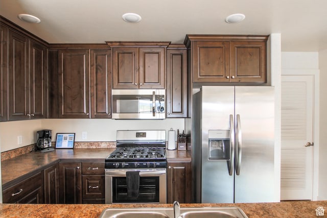 3853 S Red Valley Cir S Unit 23-A4, Moab, UT 84532 - kitchen featuring appliances with stainless steel finishes, dark brown cabinetry, and dark countertops