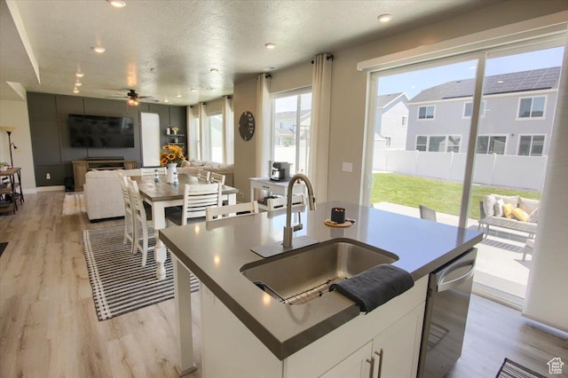 2895 S 2900 W, Syracuse, UT 84075 - kitchen featuring a sink, light wood-style floors, stainless steel dishwasher, a kitchen island with sink, and ceiling fan