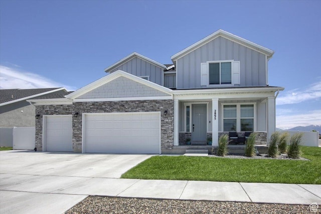 2895 S 2900 W, Syracuse, UT 84075 - craftsman-style house with board and batten siding, covered porch, an attached garage, stone siding, and driveway