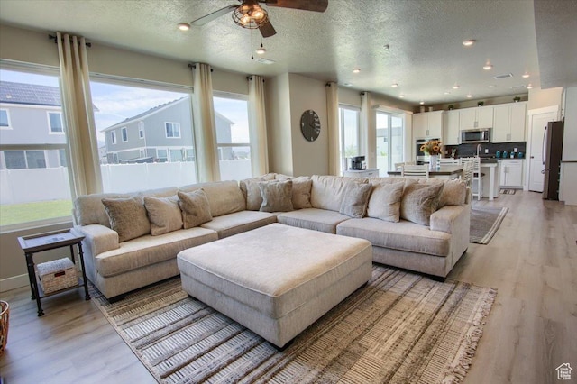 2895 S 2900 W, Syracuse, UT 84075 - living area with light wood-type flooring, a textured ceiling, ceiling fan, and recessed lighting
