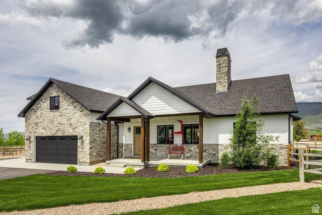 985 Hart Loop, Kamas, UT 84036 - view of front of property with a porch, stone siding, board and batten siding, a garage, and driveway