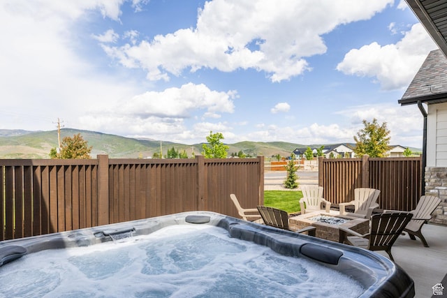 985 Hart Loop, Kamas, UT 84036 - view of patio / terrace featuring a mountain view, an outdoor fire pit, and a hot tub