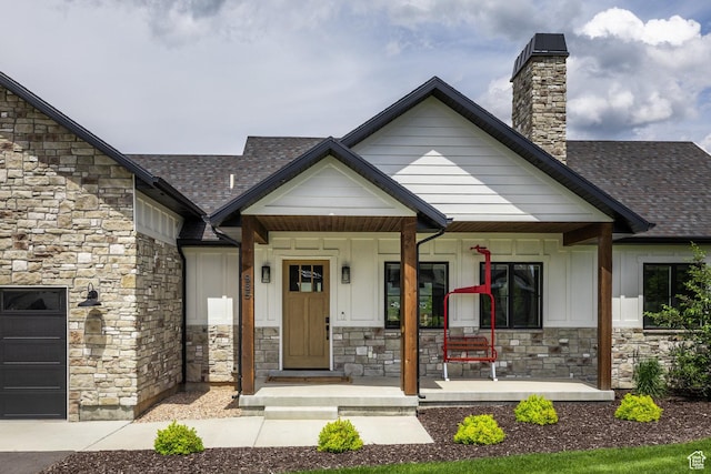 985 Hart Loop, Kamas, UT 84036 - entrance to property featuring stone siding, board and batten siding, covered porch, a chimney, and roof with shingles