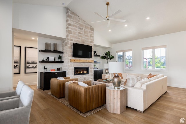 985 Hart Loop, Kamas, UT 84036 - living area featuring a ceiling fan, high vaulted ceiling, light wood finished floors, a fireplace, and baseboards