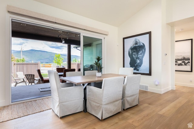 985 Hart Loop, Kamas, UT 84036 - dining space featuring light wood-type flooring, baseboards, lofted ceiling, and a mountain view