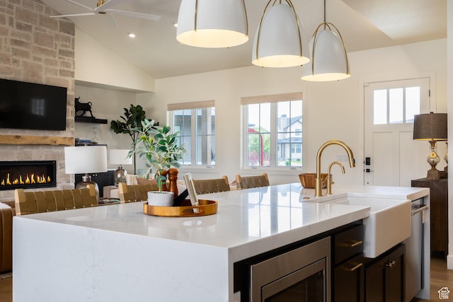 985 Hart Loop, Kamas, UT 84036 - kitchen with an island with sink, a sink, open floor plan, a fireplace, and pendant lighting