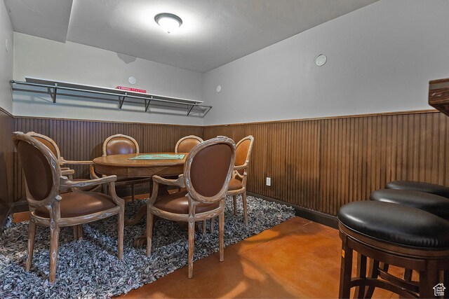 2300 Comstock Dr, Park City, UT 84060 - dining space with wainscoting, concrete floors, and wooden walls