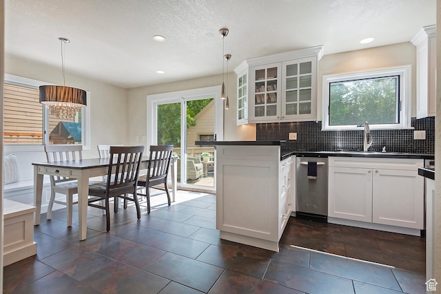 2300 Comstock Dr, Park City, UT 84060 - kitchen featuring dark countertops, glass insert cabinets, decorative backsplash, white cabinets, and a sink
