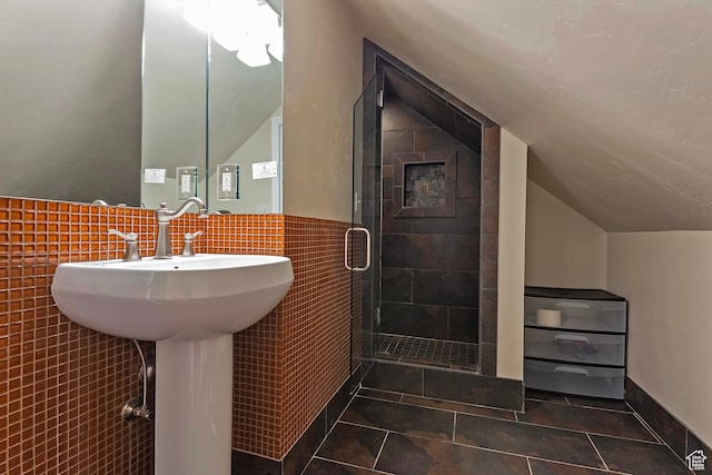2300 Comstock Dr, Park City, UT 84060 - full bathroom with vaulted ceiling, tile walls, tile patterned floors, a shower stall, and a wainscoted wall