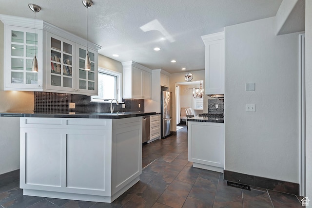 2300 Comstock Dr, Park City, UT 84060 - kitchen with stainless steel appliances, dark countertops, tasteful backsplash, glass insert cabinets, and white cabinets