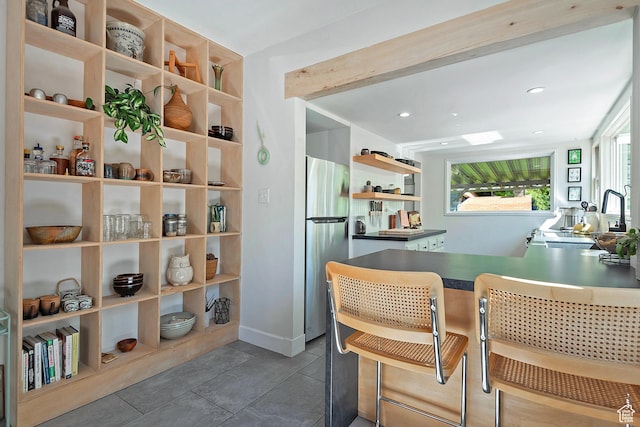 271 E Kensington Ave S, Salt Lake City, UT 84115 - kitchen with open shelves, freestanding refrigerator, a sink, recessed lighting, and a kitchen breakfast bar