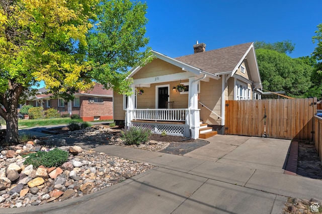 271 E Kensington Ave S, Salt Lake City, UT 84115 - view of front of house with covered porch, a chimney, a shingled roof, and a gate