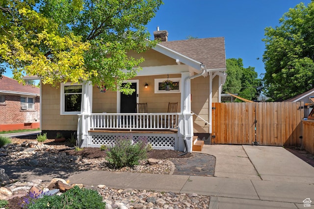 271 E Kensington Ave S, Salt Lake City, UT 84115 - view of front of house with covered porch, a gate, roof with shingles, and a chimney