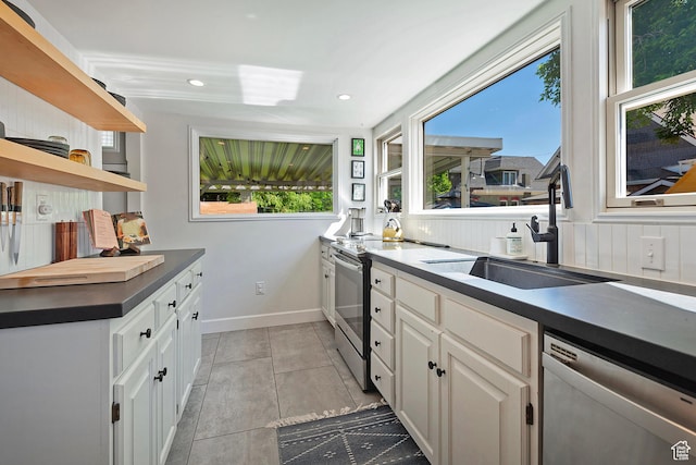 271 E Kensington Ave S, Salt Lake City, UT 84115 - kitchen with stainless steel appliances, open shelves, dark countertops, a sink, and plenty of natural light