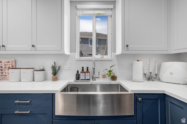 7935 S 2800 W, West Jordan, UT 84088 - kitchen with blue cabinets, a sink, white cabinetry, and light countertops