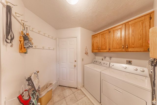 145 Deer Run Ln, Layton, UT 84040 - laundry area featuring cabinet space, independent washer and dryer, light tile patterned flooring, and a textured ceiling