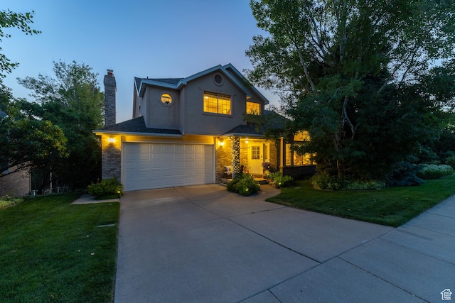 145 Deer Run Ln, Layton, UT 84040 - traditional-style home featuring a garage, driveway, a chimney, a yard, and stucco siding
