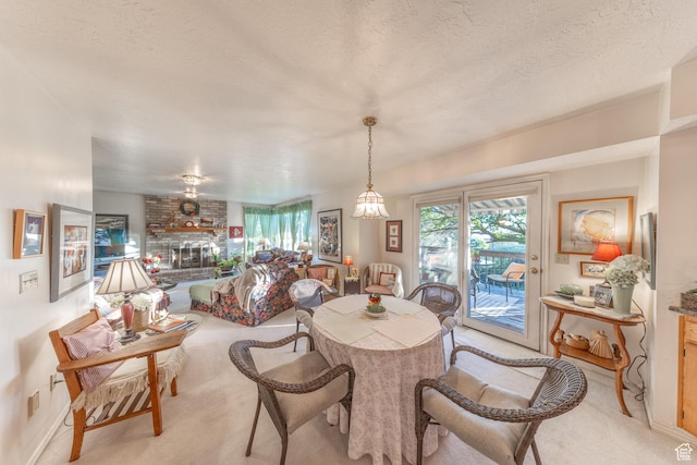 145 Deer Run Ln, Layton, UT 84040 - dining space with light carpet, a brick fireplace, baseboards, and a textured ceiling