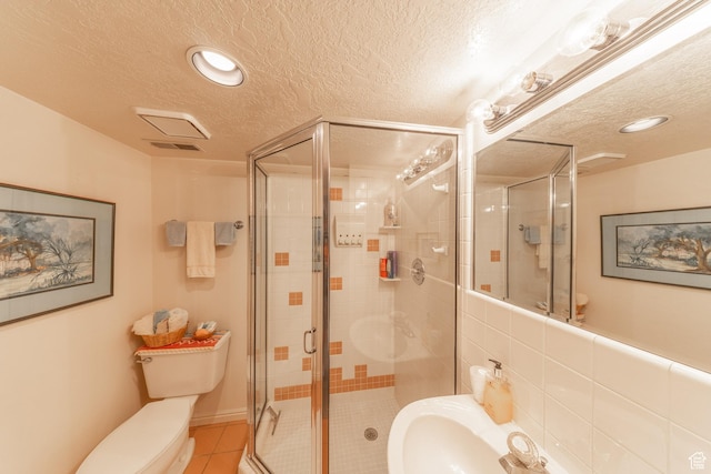 145 Deer Run Ln, Layton, UT 84040 - full bath featuring toilet, a textured ceiling, a shower stall, tile patterned floors, and recessed lighting