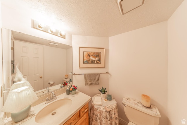 145 Deer Run Ln, Layton, UT 84040 - bathroom with toilet, vanity, and a textured ceiling