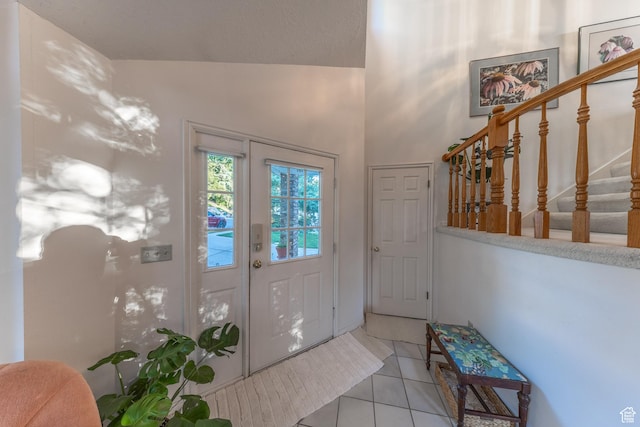 145 Deer Run Ln, Layton, UT 84040 - foyer entrance featuring stairs, light tile patterned floors, and vaulted ceiling