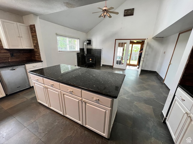 3013 N 100 W, Provo, UT 84604 - kitchen featuring dishwasher, a wood stove, white cabinetry, a ceiling fan, and baseboards
