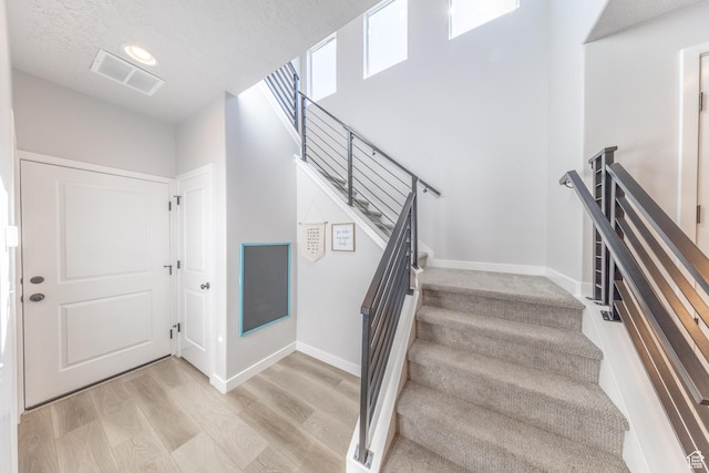 3333 W 3745th St S, West Haven, UT 84401 - stairway featuring wood finished floors and a textured ceiling