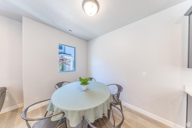 3333 W 3745th St S, West Haven, UT 84401 - dining space featuring light wood finished floors, baseboards, and a textured ceiling