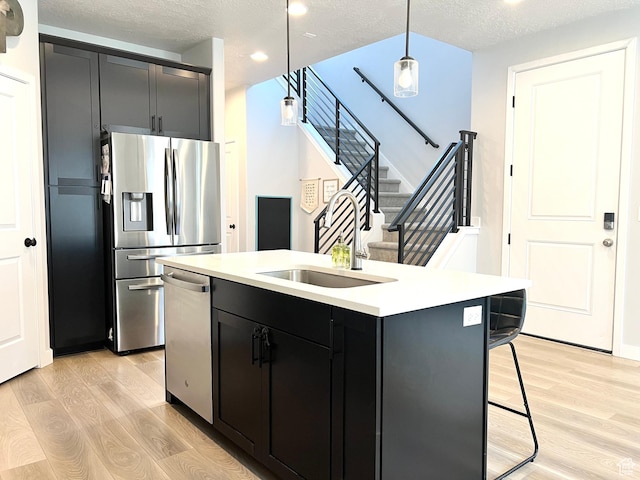 3333 W 3745th St S, West Haven, UT 84401 - kitchen featuring appliances with stainless steel finishes, light wood finished floors, light countertops, an island with sink, and recessed lighting