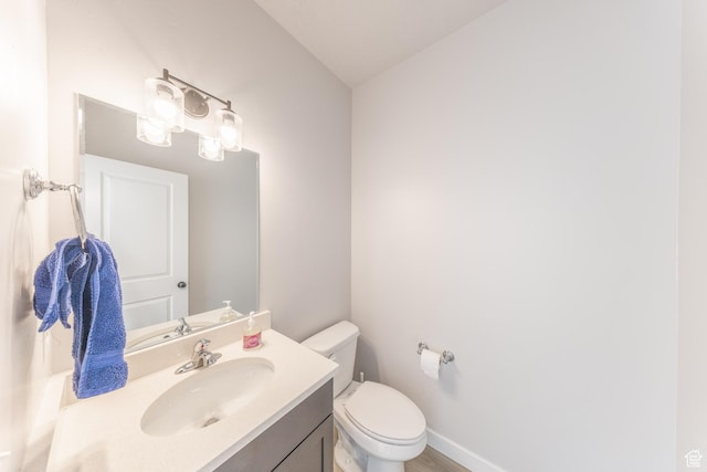 3333 W 3745th St S, West Haven, UT 84401 - bathroom with vanity, toilet, baseboards, and wood finished floors