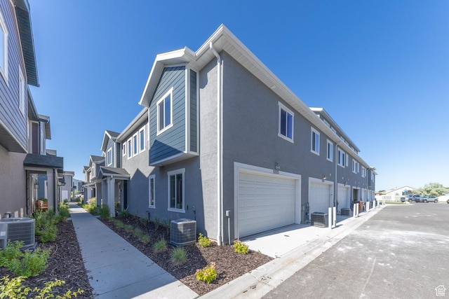 3333 W 3745th St S, West Haven, UT 84401 - view of home's exterior with central AC, a residential view, a garage, and stucco siding