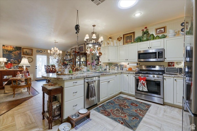 2198 W 1465 N, St George, UT 84770 - kitchen with stainless steel appliances, a chandelier, a peninsula, white cabinets, and lofted ceiling