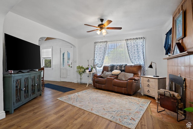160 S 200 W, Tooele, UT 84074 - living area with arched walkways, ceiling fan, light wood-style floors, and baseboards